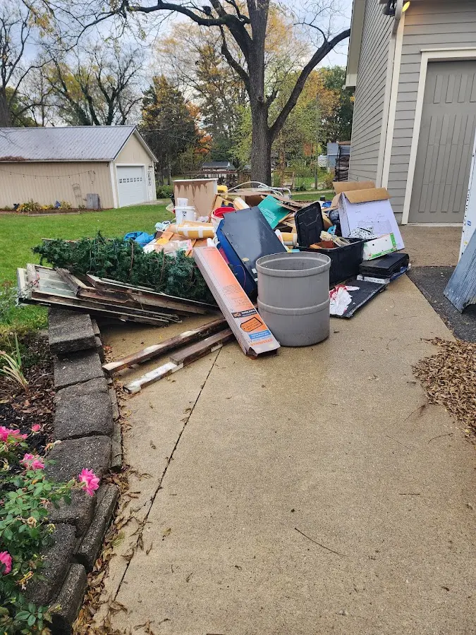 Dumpster being loaded with debris for 3 Yard Dumpster Rental in Hope Mills
